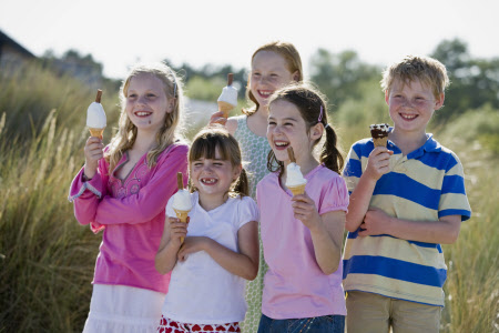 Children with ice-cream on the beach at Studland, Dorset