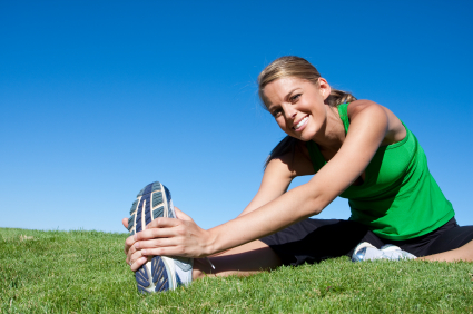woman exercising outdoor smiling while posing for london mums magazine