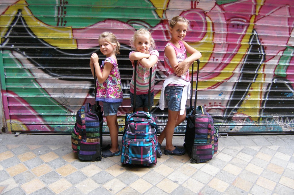 kids in paris with luggage posing for mums magazine
