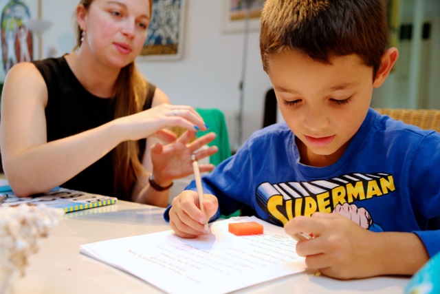 Diego being tutored at home while posing for mums magazine