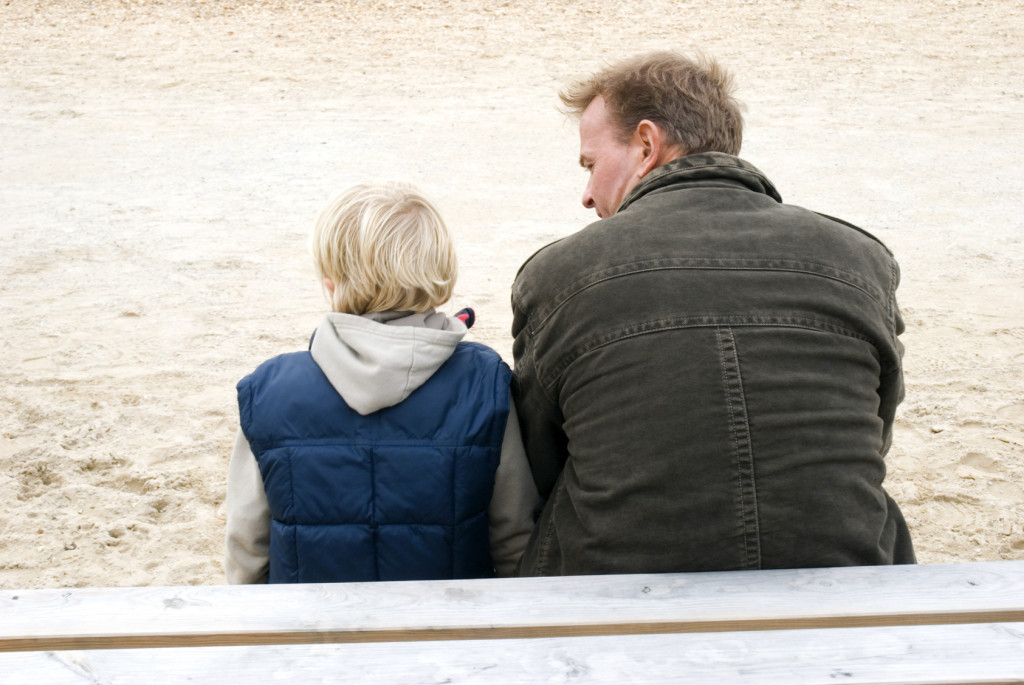 Father and son sitting together.