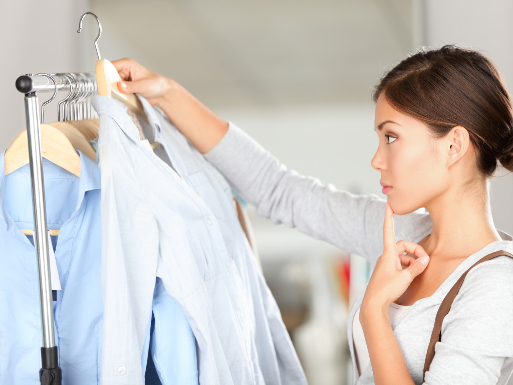 review next season's fashion women holding clothing 