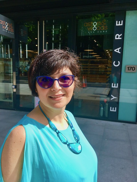 woman wearing turquoise top and blue spectacles posing for mums magazine