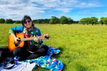 Monica playing the guitar in richmond park