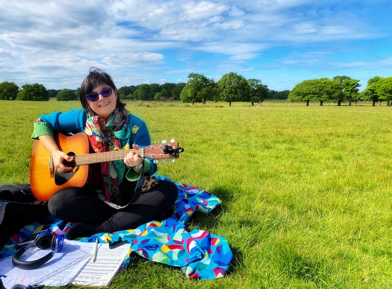 Monica playing the guitar in richmond park