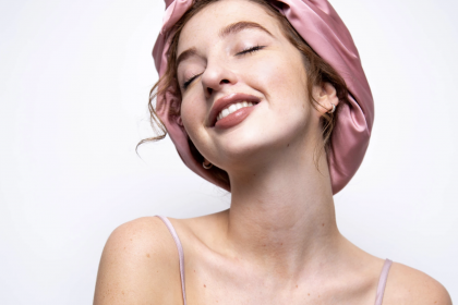 woman wearing a pink hair towel smiling and posing for mums magazine