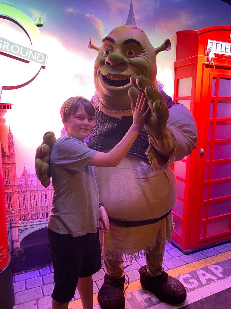 teenage boy posing with shrek in London for mums magazine 