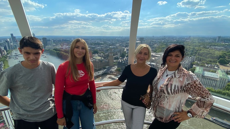 Mums and teenagers on board of a capsule on the London Eye posing for mums magazine