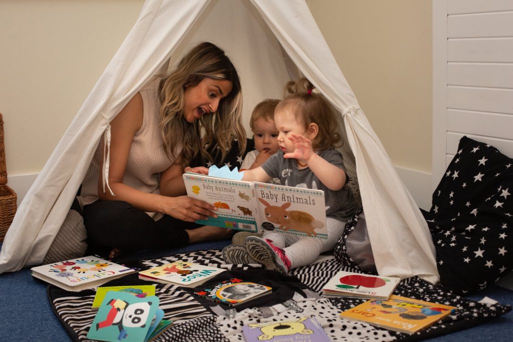 mum and baby looking at each other reading posing for mums magazine