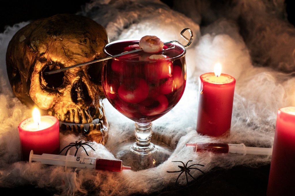 halloween cocktail Zombie Brains with red juice and skull decoration