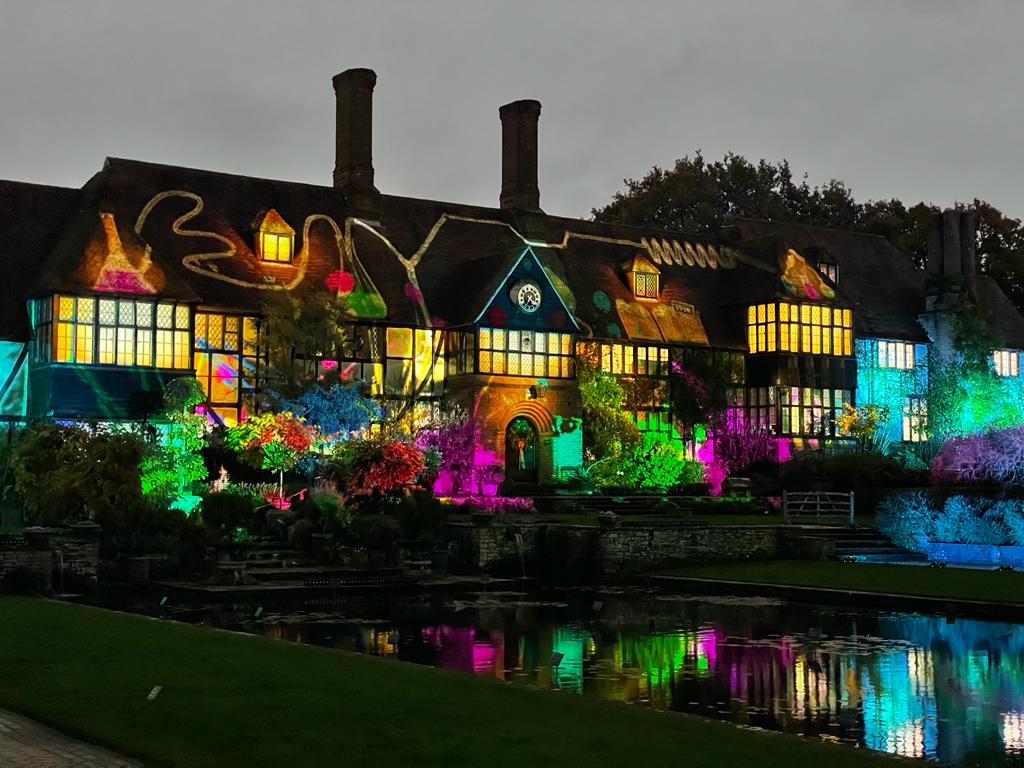 Houses lit with colourful lights at the Christmas glow walk at RHS Garden Wisley 