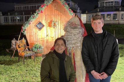 mummy blogger and teenage son posing with santa at his grotto for mums magazine at Kew Gardens
