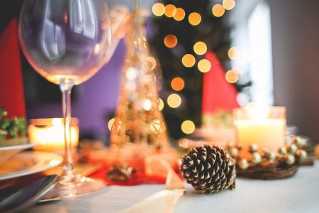 table decorated for Christmas dinner and pine cone and fairy lights