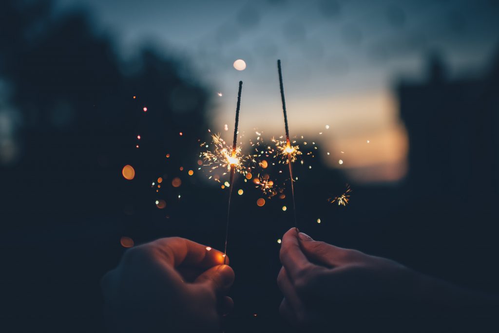 people holding sparkles 