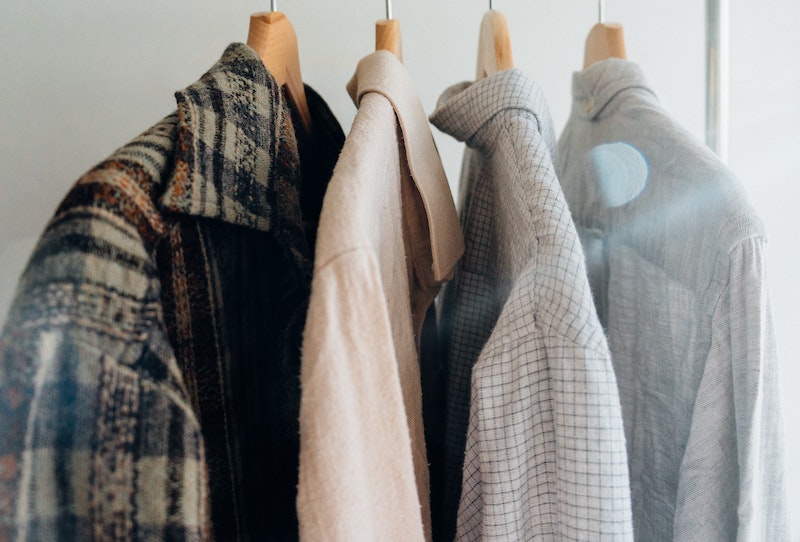 woman's wardrobe including men's jackets in grey cream and blue 