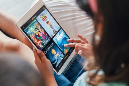 child reading disney magazines on the smartphone