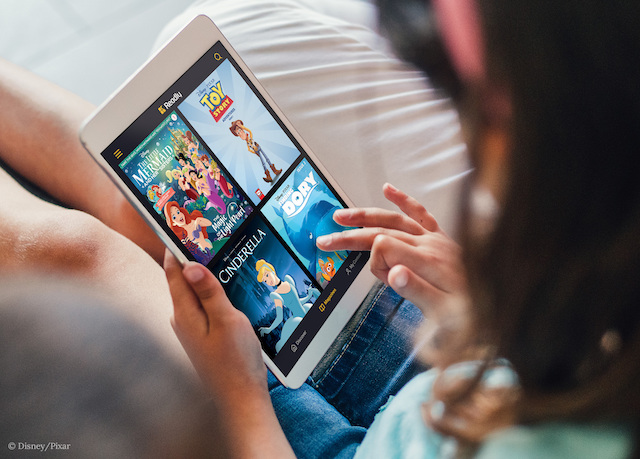 child reading disney magazines on the smartphone 