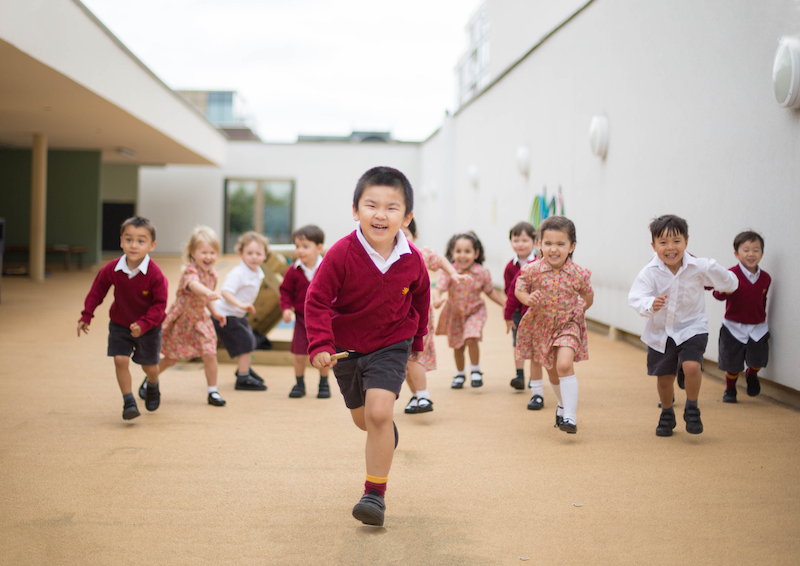 chinese boy running in a school hall at Kensington wade 