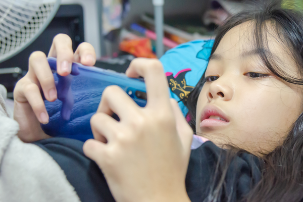 Young girl playing games on a smartphone 
