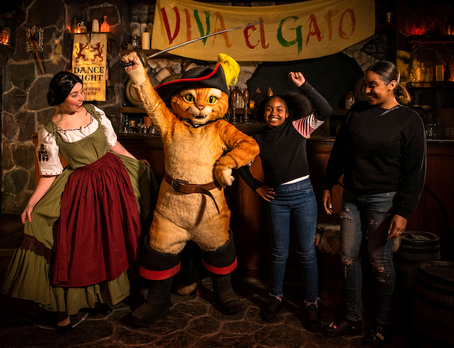 puss in boots with kids posing for mums magazine  at SHREKS ADVENTURE london attraction