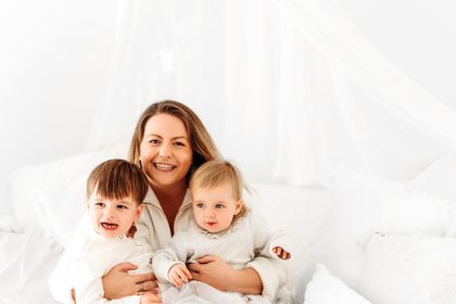 mum embracing her two children posing for mums magazine