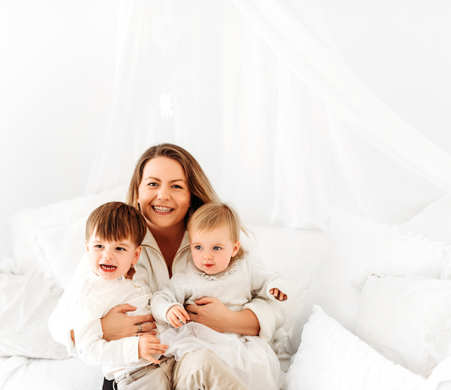 mum embracing her two children posing for mums magazine 