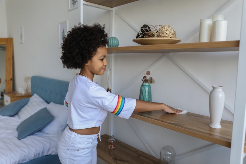lady cleaning a bedroom