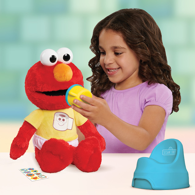 Potty Time Elmo - girl playing with Elmo during potty training 