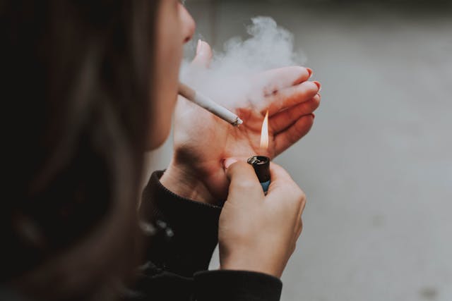 woman smoking - Photo by lil artsy