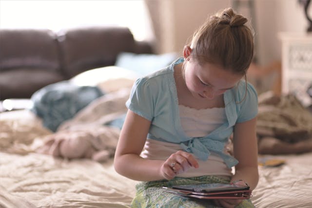 screen time child looking at smartphone