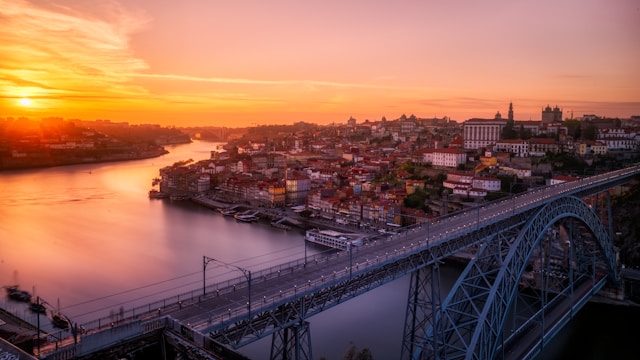 gray bridge near building at sunsetThe Porto